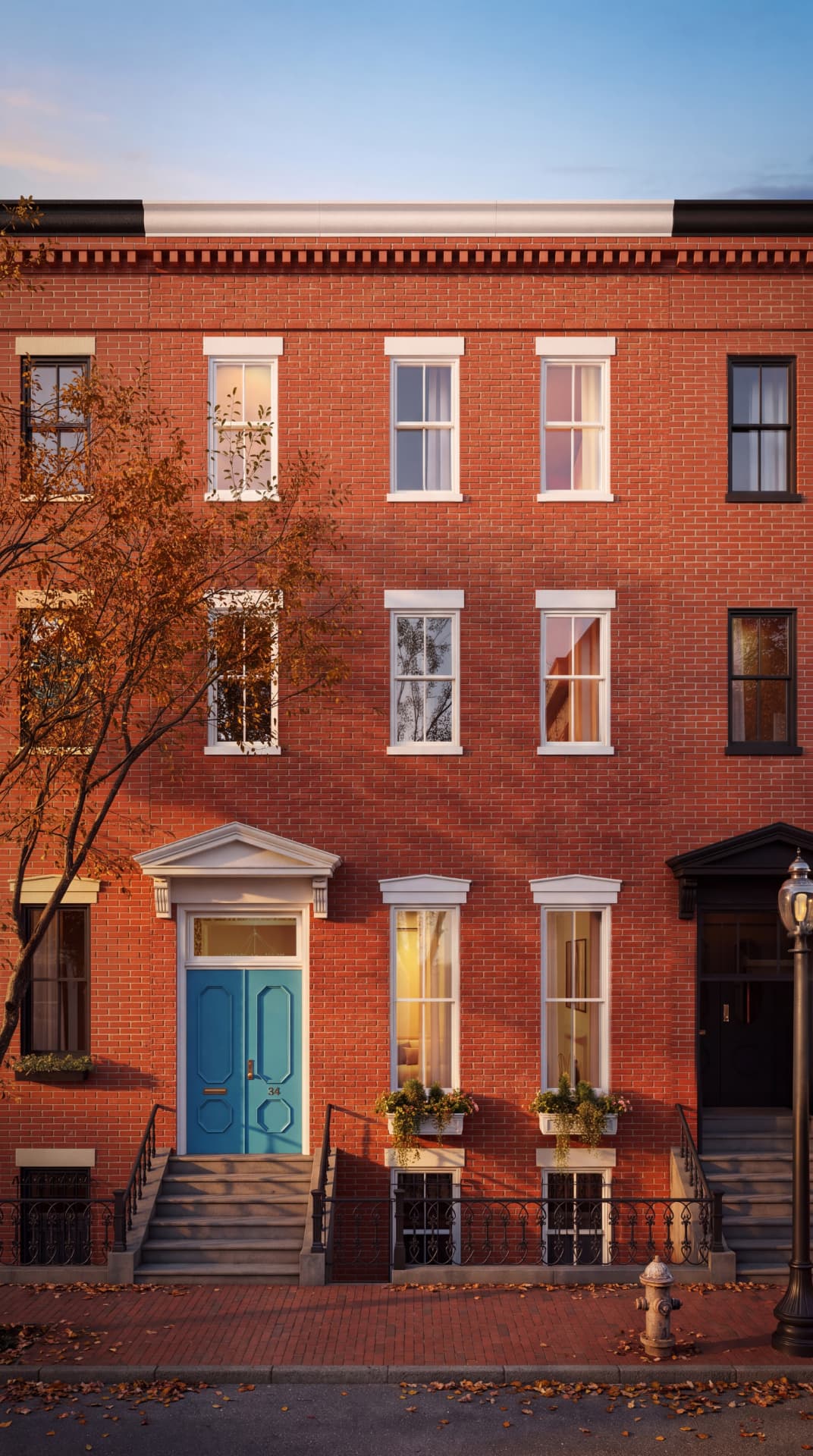 The Tiffany Townhouse at 34 Milford St: a red brick facade with a turquoise double front door, tall white-trimmed windows and stone steps